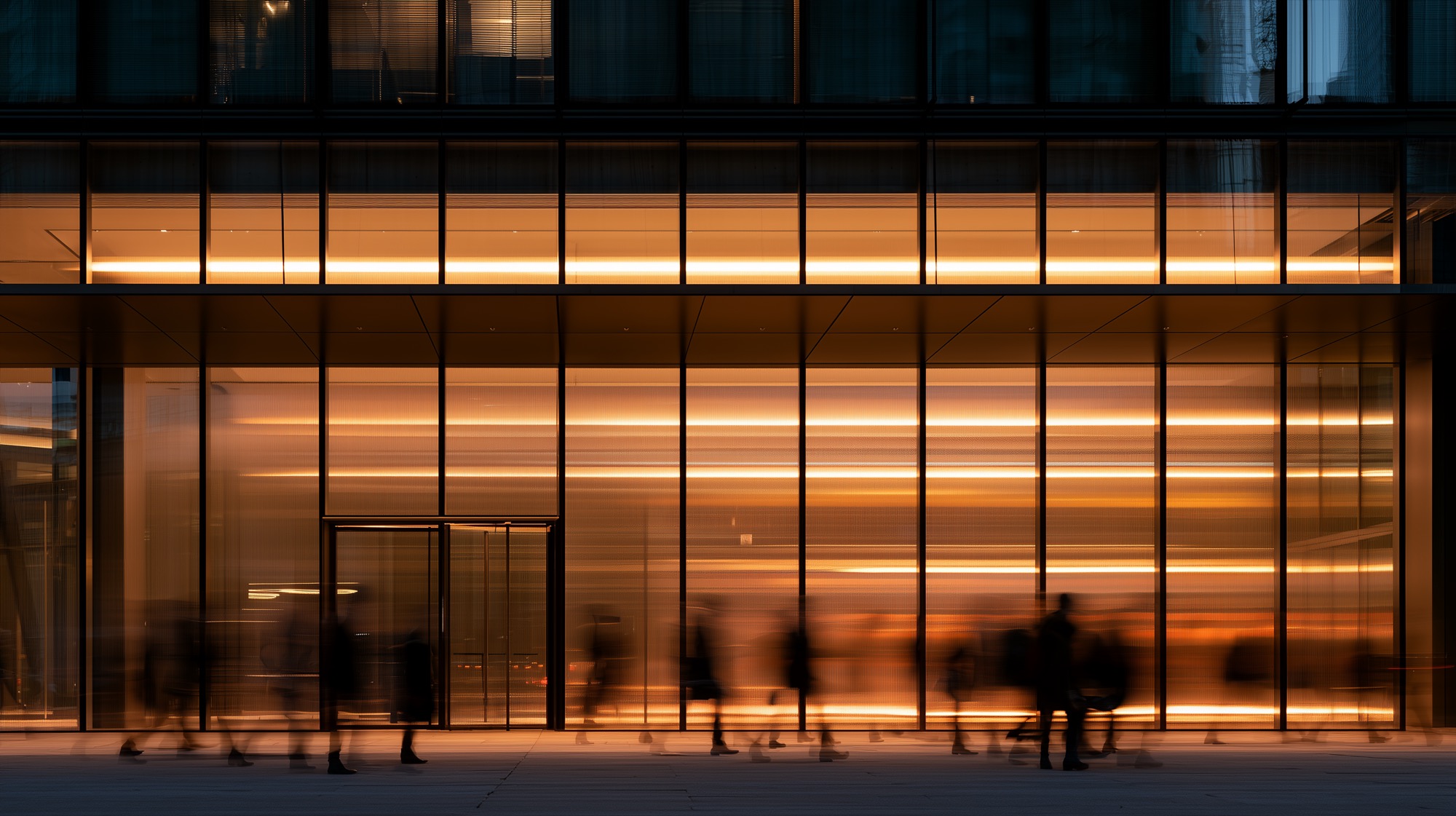 An office building lit from within at dusk
