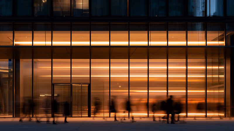 An office building lit from within at dusk